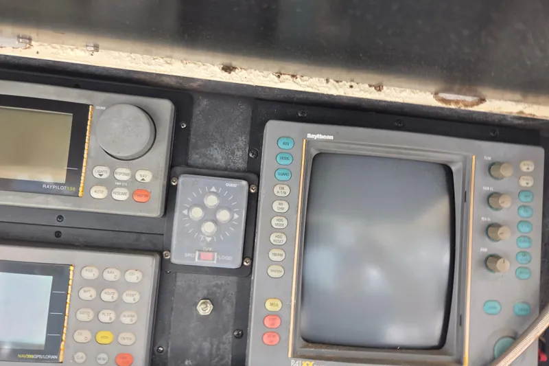 Slide: The Image of Control panel of a 1990 Egg Harbor Golden Egg 42 boat with navigation instruments. - 31