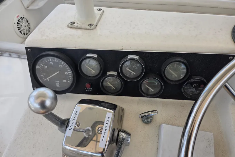 Slide: The Image of Control panel of a 1990 Egg Harbor Golden Egg 42 boat with gauges and throttle. - 32