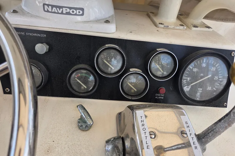Slide: The Image of Control panel of a 1990 Egg Harbor Golden Egg 42 boat with gauges and throttle. - 33