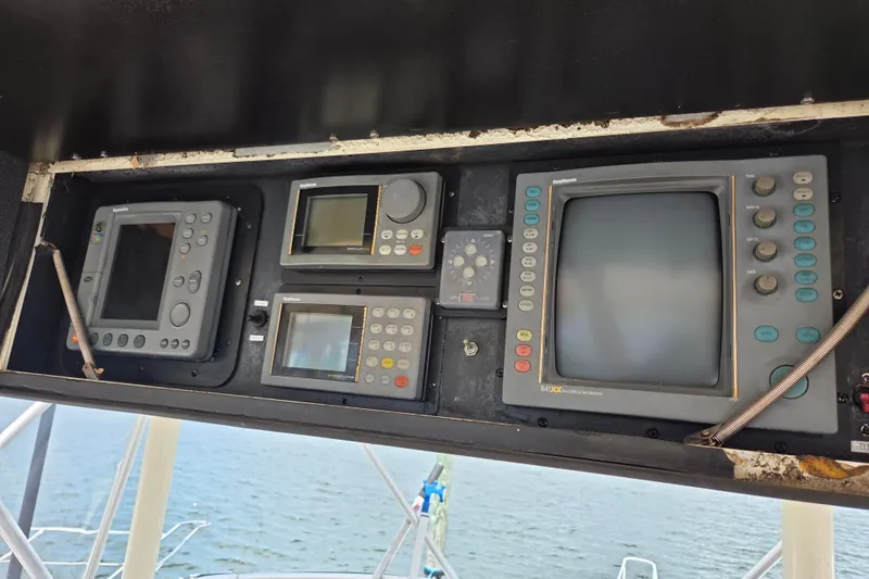 Slide: The Image of Control panel of a 1990 Egg Harbor Golden Egg 42 boat with navigation equipment. - 34