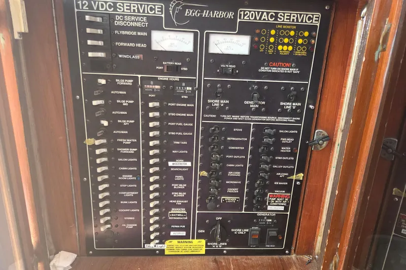 Slide: The Image of Electrical panel of a 1990 Egg Harbor Golden Egg 42 boat, showing switches and gauges. - 36