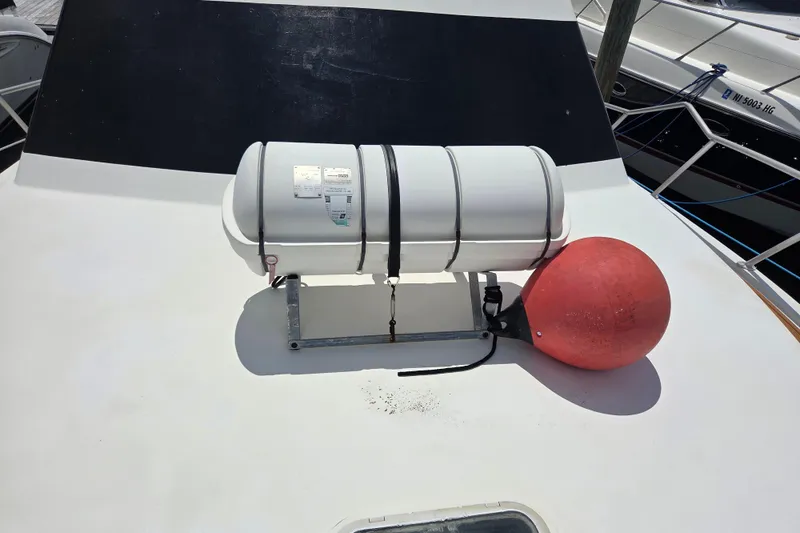 Slide: The Image of Life raft and buoy on 1990 Egg Harbor Golden Egg 42 yacht deck. - 37