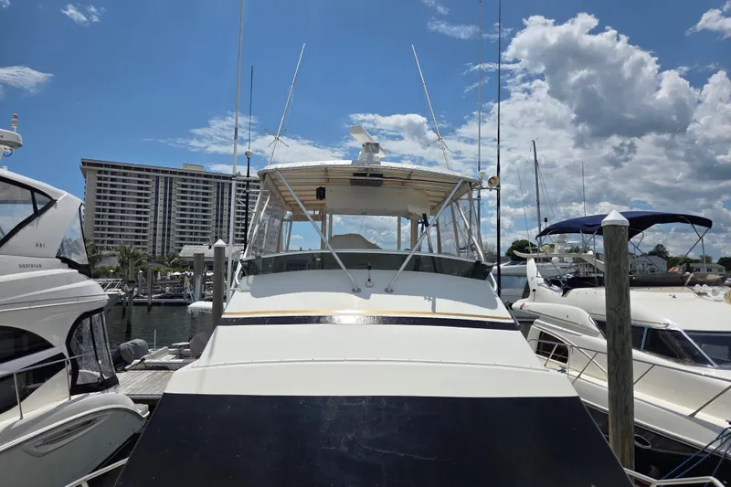 Slide: The Image of 1990 Egg Harbor Golden Egg 42 yacht docked at marina under blue sky. - 6