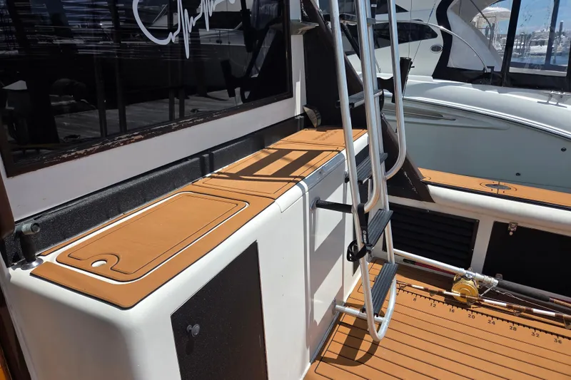 Slide: The Image of 1990 Egg Harbor Golden Egg 42 boat deck with ladder and fishing rod holder. - 8