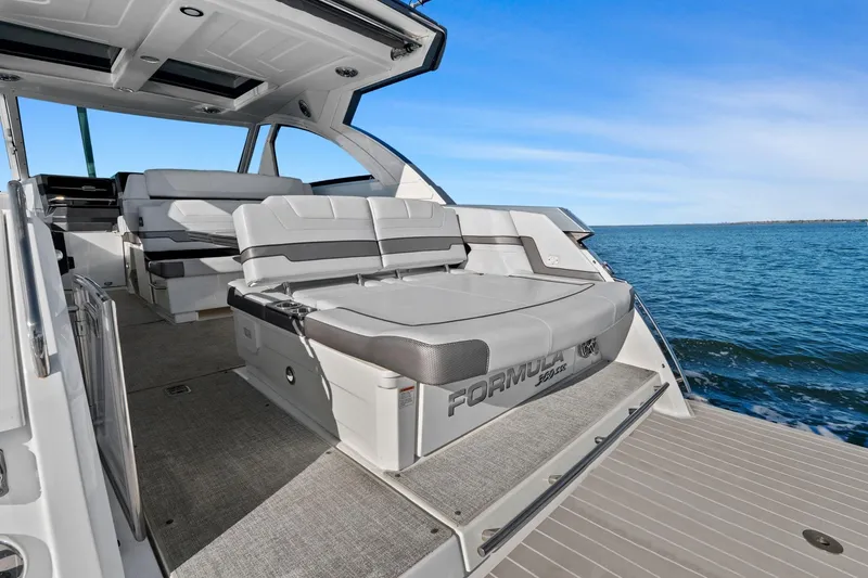 Slide: The Image of 2023 Formula 380 Super Sport Crossover OB boat interior with luxurious seating on open water. - 10