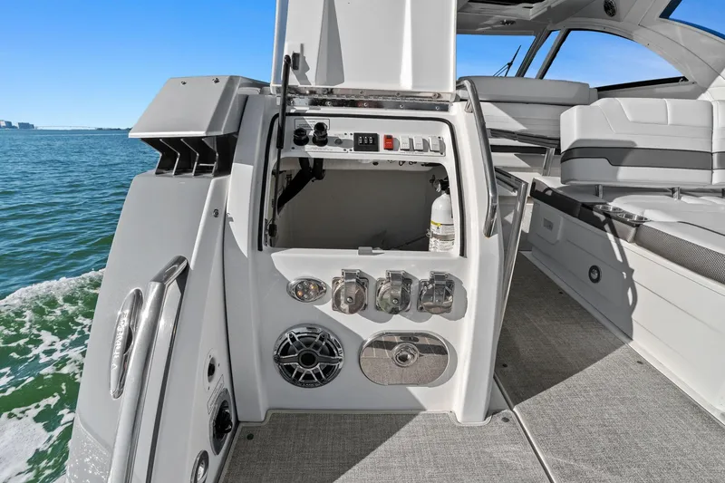 Slide: The Image of 2023 Formula 380 Super Sport Crossover OB boat interior with control panel and seating. - 14