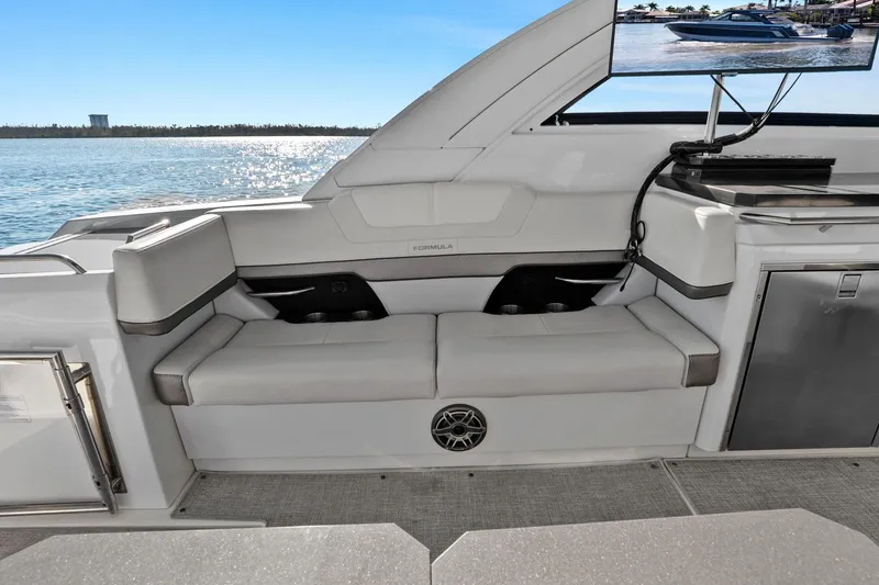 Slide: The Image of 2023 Formula 380 Super Sport Crossover OB interior with seating and entertainment area. - 15