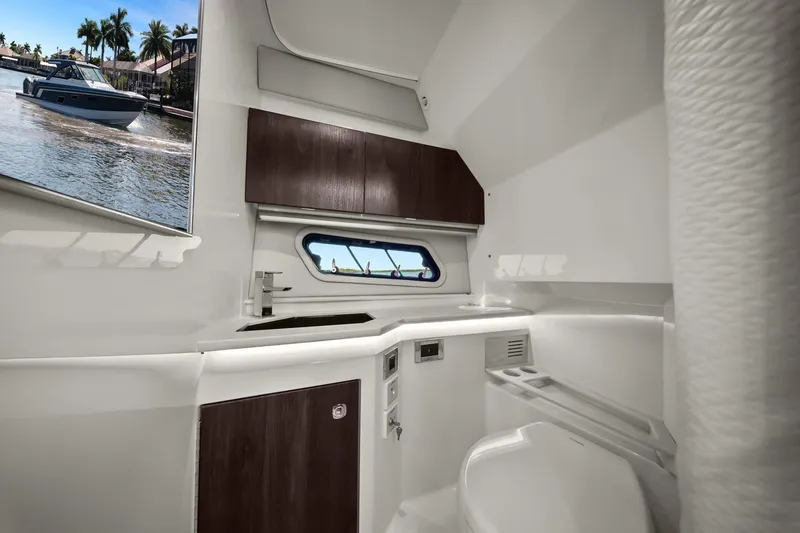 Slide: The Image of Interior of 2023 Formula 380 Super Sport Crossover OB boat, featuring sleek bathroom design. - 16