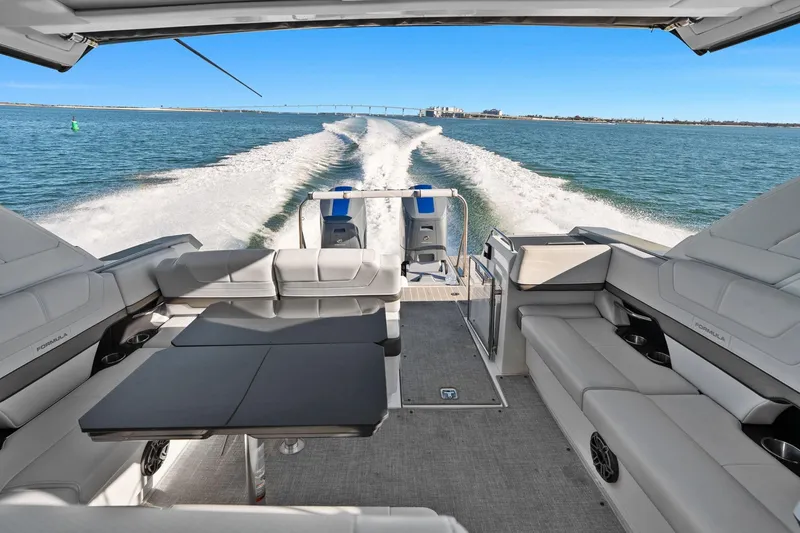 Slide: The Image of 2023 Formula 380 Super Sport Crossover OB cruising on open water, showcasing luxurious seating. - 17
