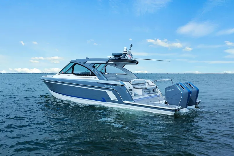 Slide: The Image of 2023 Formula 380 Super Sport Crossover OB cruising on open water under clear skies. - 2