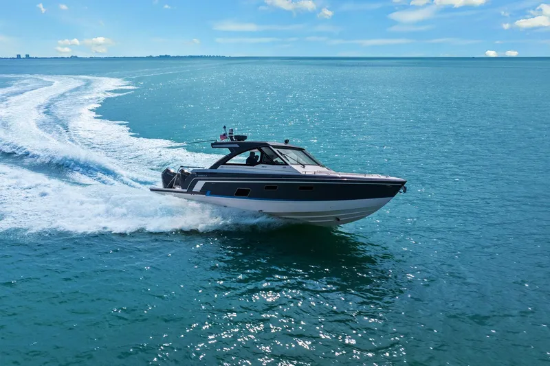 Slide: The Image of 2023 Formula 380 Super Sport Crossover OB cruising on open blue water. - 7