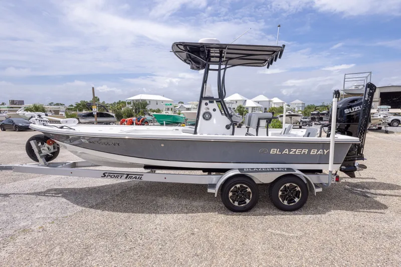 Slide: The Image of 2023 Blazer Bay 2200 boat on trailer, parked outdoors under cloudy sky. - 10