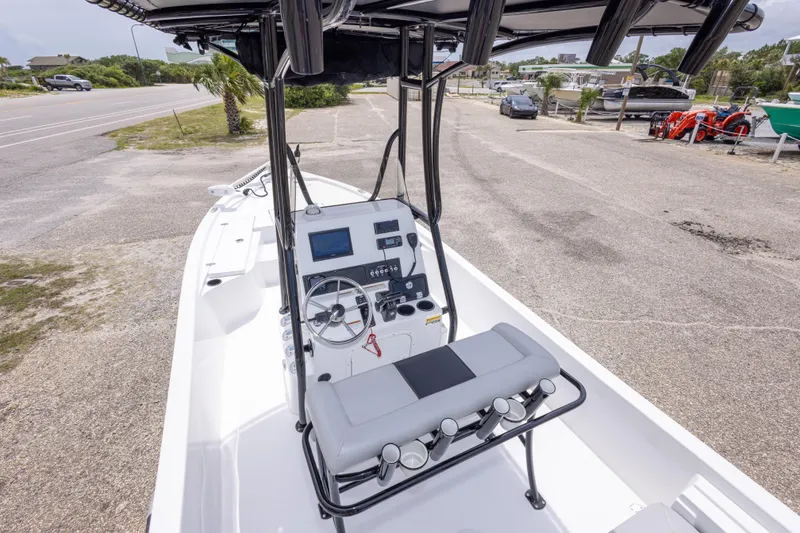 Slide: The Image of 2023 Blazer Bay 2200 boat interior with steering console and seating, parked on a lot. - 21