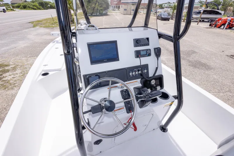 Slide: The Image of 2023 Blazer Bay 2200 boat console with steering wheel and navigation equipment. - 24