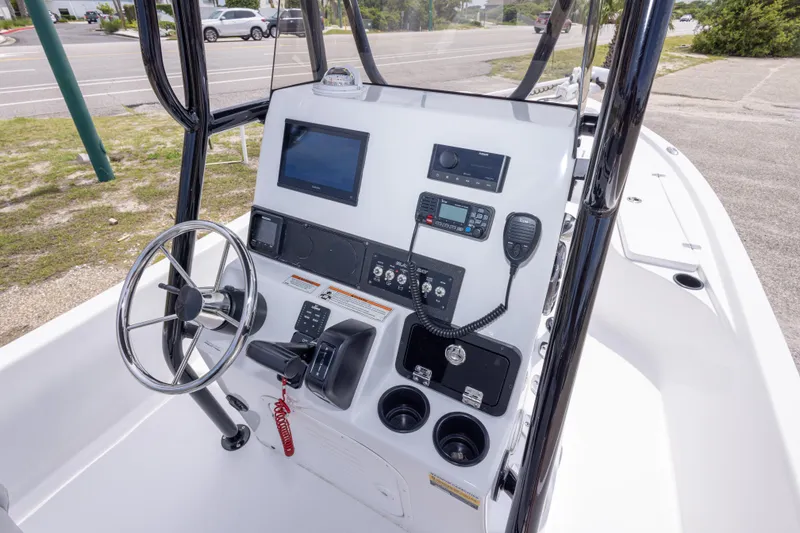 Slide: The Image of 2023 Blazer Bay 2200 boat console with steering wheel and electronic controls. - 25