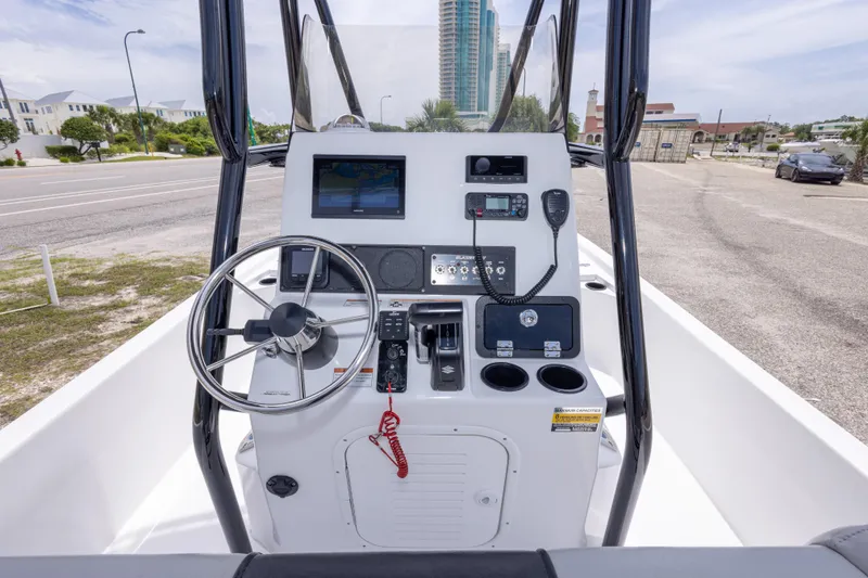 Slide: The Image of 2023 Blazer Bay 2200 boat console with steering wheel and navigation equipment. - 26