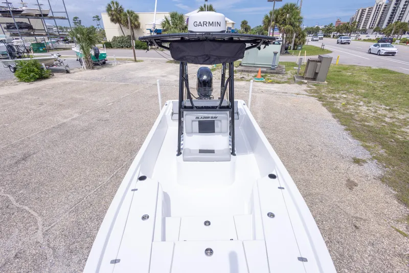 Slide: The Image of 2023 Blazer Bay 2200 boat with Garmin equipment, parked outdoors on a sunny day. - 35