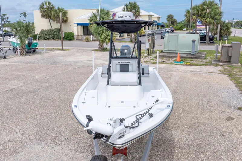Slide: The Image of 2023 Blazer Bay 2200 boat with Garmin equipment, parked outdoors on a sunny day. - 4