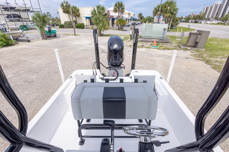 Slide: The Image of 2023 Blazer Bay 2200 boat interior with steering wheel and seating, parked outdoors. - 41