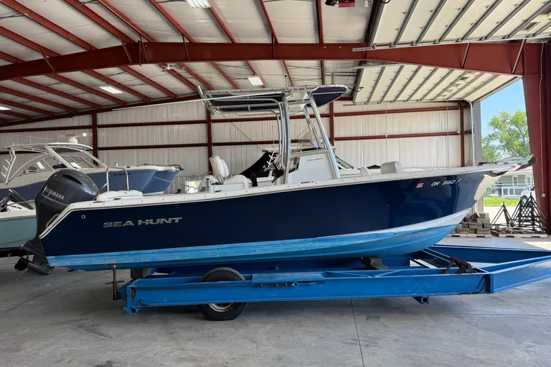Slide: The Image of 2015 Sea Hunt Ultra 234 boat on trailer in indoor storage facility. - 1