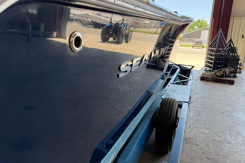 Slide: The Image of 2015 Sea Hunt Ultra 234 boat on trailer in a garage setting. - 2