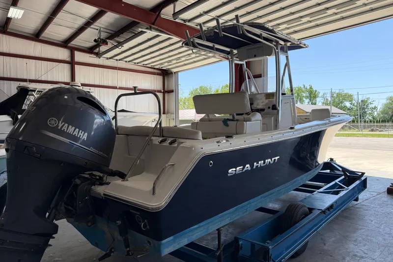 Slide: The Image of 2015 Sea Hunt Ultra 234 boat with Yamaha engine in a garage setting. - 4