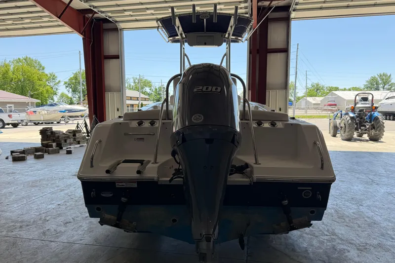 Slide: The Image of 2015 Sea Hunt Ultra 234 boat with 200 HP engine in a garage setting. - 5