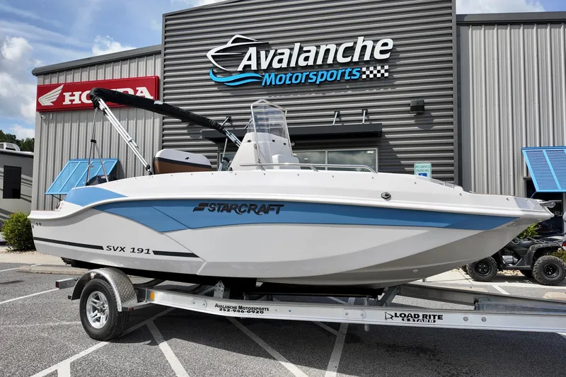The Image of 2026 Starcraft SVX 191 OB CC boat on trailer at Avalanche Motorsports dealership. - 1