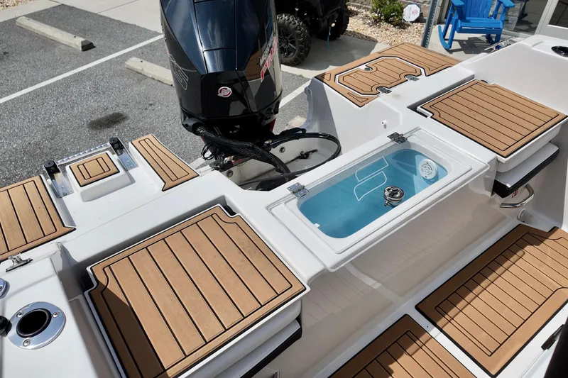 Slide: The Image of 2026 Starcraft SVX 191 OB CC boat with teak deck and outboard motor. - 13