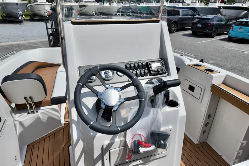 Slide: The Image of 2026 Starcraft SVX 191 OB CC boat cockpit with steering wheel and control panel. - 14