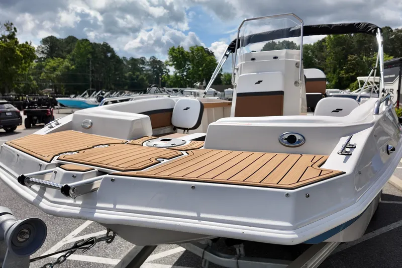 Slide: The Image of 2026 Starcraft SVX 191 OB CC boat with sleek deck design, parked outdoors. - 2