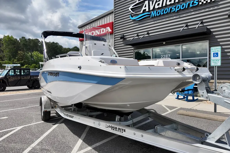 Slide: The Image of 2026 Starcraft SVX 191 OB CC boat on trailer at dealership, showcasing sleek design. - 5