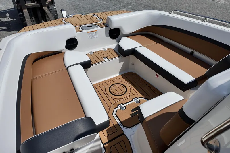Slide: The Image of 2026 Starcraft SVX 191 OB CC boat interior with brown and white seating, teak flooring. - 7