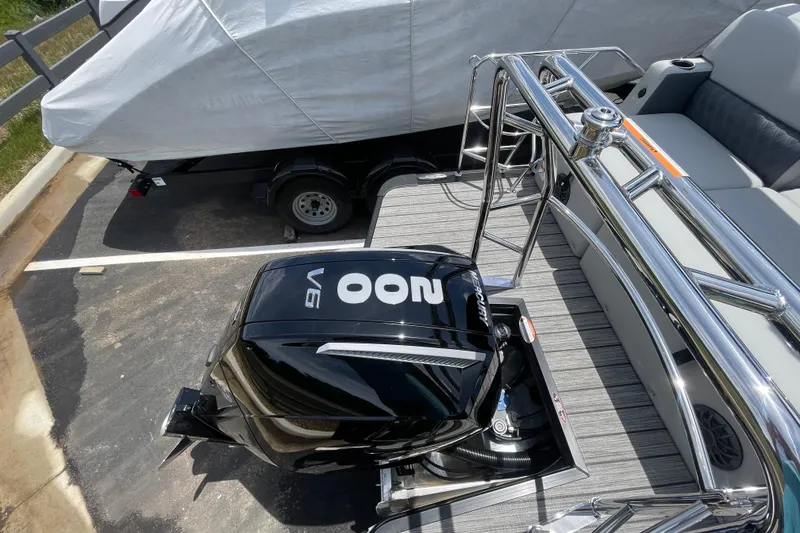 Slide: The Image of 2026 Harris Cruiser 230 SLDH with powerful V6 Mercury outboard engine, parked on trailer. - 10
