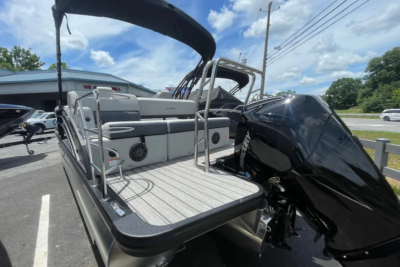 Slide: The Image of 2026 Harris Cruiser 230 SLDH pontoon boat with powerful Mercury engine, parked outdoors. - 3
