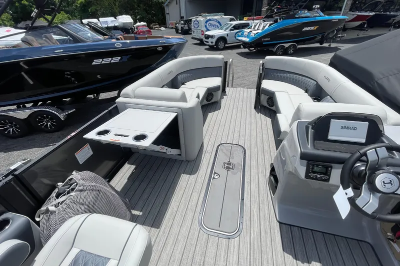 Slide: The Image of 2026 Harris Cruiser 230 SLDH pontoon boat interior with seating and steering console. - 5