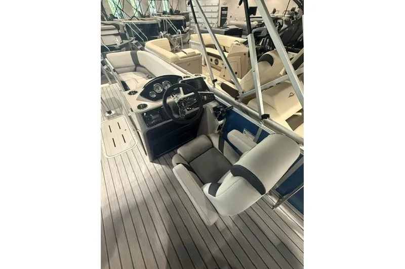 Slide: The Image of 2026 SunCatcher Select 322SL boat interior with steering console and seating. - 7