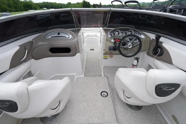 Slide: The Image of 2008 Crownline 230 LS boat interior with white seating and modern dashboard controls. - 12