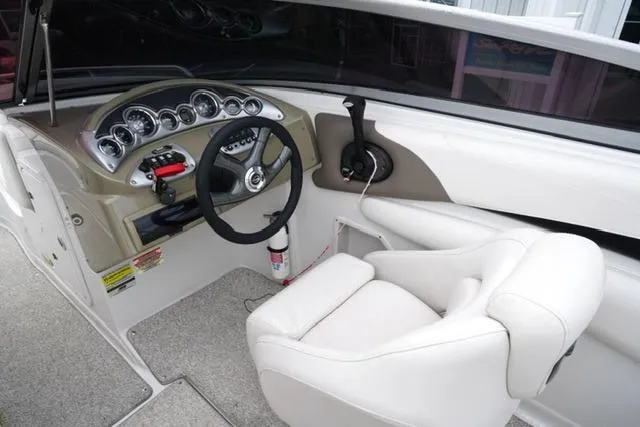 Slide: The Image of 2008 Crownline 230 LS boat interior with steering wheel and dashboard controls. - 13