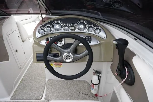 Slide: The Image of 2008 Crownline 230 LS boat dashboard with steering wheel and control panel. - 14