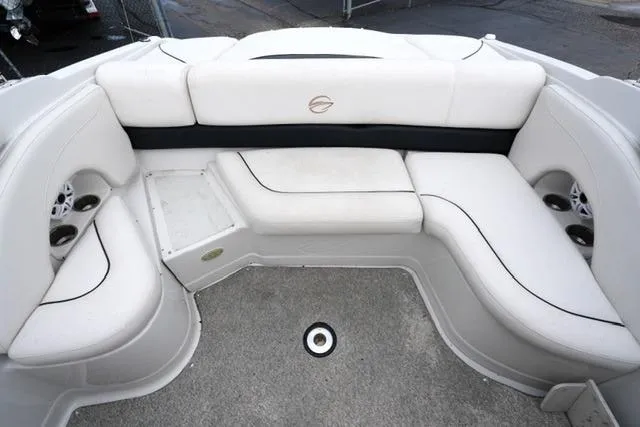 Slide: The Image of 2008 Crownline 230 LS boat interior with white cushioned seating and cup holders. - 15