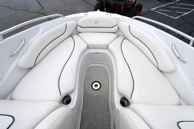 Slide: The Image of 2008 Crownline 230 LS boat interior with white cushioned seating and gray flooring. - 9