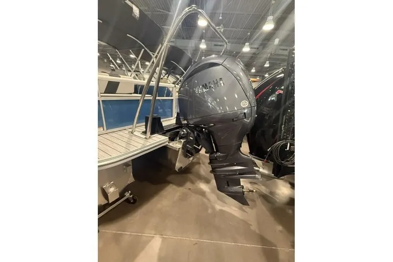 Slide: The Image of 2026 SunCatcher Select 322SL boat with Yamaha outboard motor in showroom. - 6