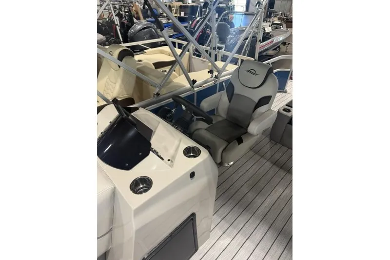 Slide: The Image of 2026 SunCatcher Select 322SL boat interior with steering console and captain's chair. - 8