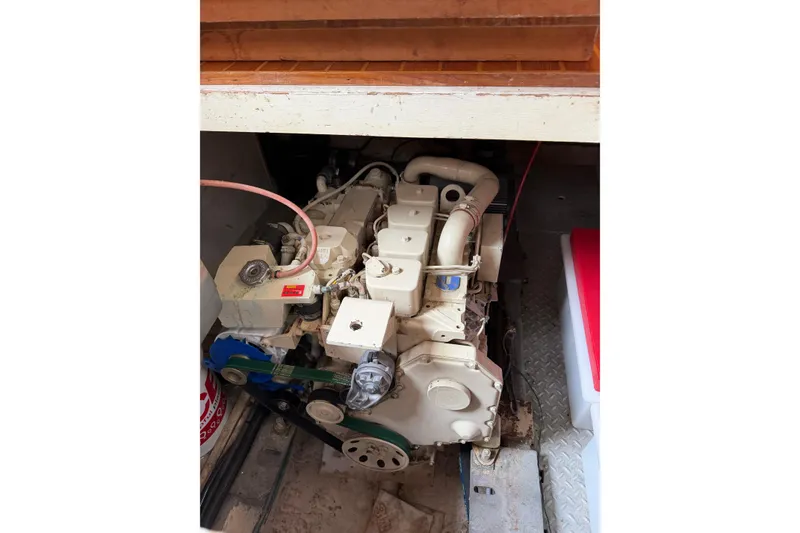 Slide: The Image of Engine compartment of a 1988 Monk 36 boat, showcasing mechanical components and wiring. - 32