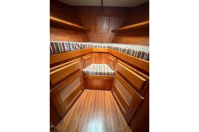 Slide: The Image of Cozy wooden cabin interior of 1988 Monk 36 boat with striped cushions. - 13