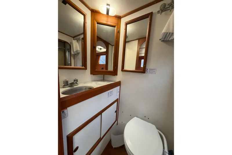 Slide: The Image of Compact bathroom in 1988 Monk 36 boat with sink, mirror, and toilet. - 20