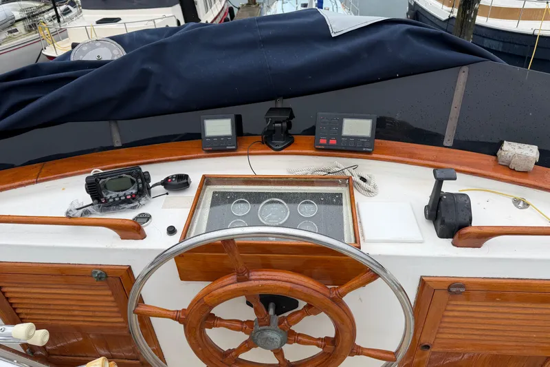 Slide: The Image of Helm of 1988 Monk 36 boat with wooden wheel and navigation instruments. - 26