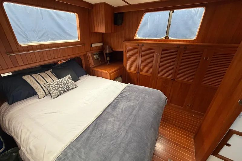 Slide: The Image of Cozy bedroom in 1988 Monk 36 yacht with wooden interior and large windows. - 18