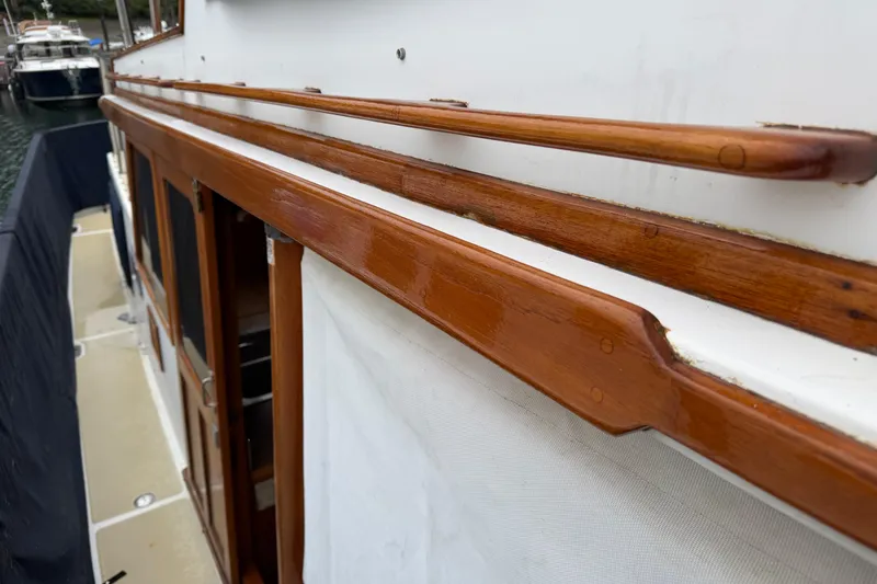 Slide: The Image of 1988 Monk 36 boat with polished wooden railings and white canvas cover. - 29